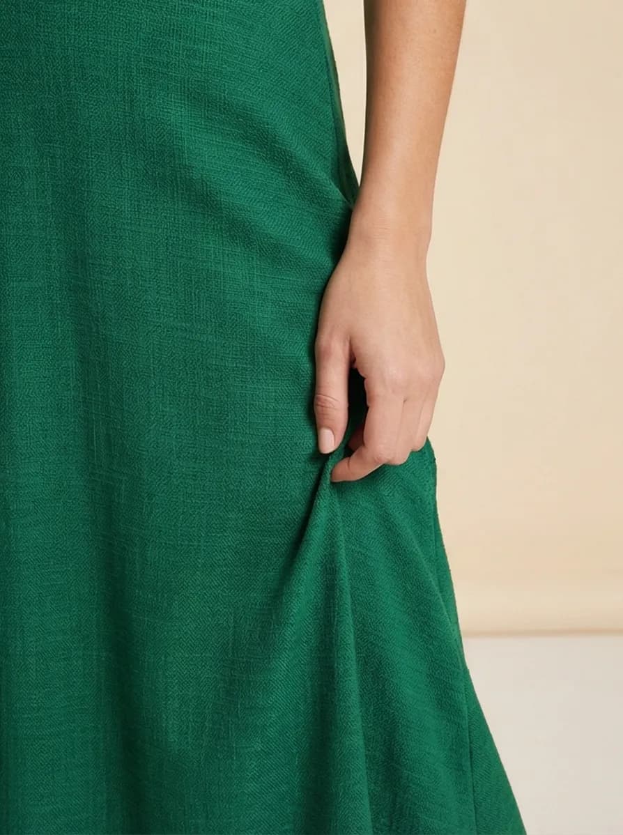 AI-generated lifestyle photo of green dress, variant 4: fabric detail close-up